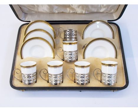 Part set of Wedgwood china coffee cans with silver mounts, five cups and five saucers, in a fitted case, Sheffield 1922 