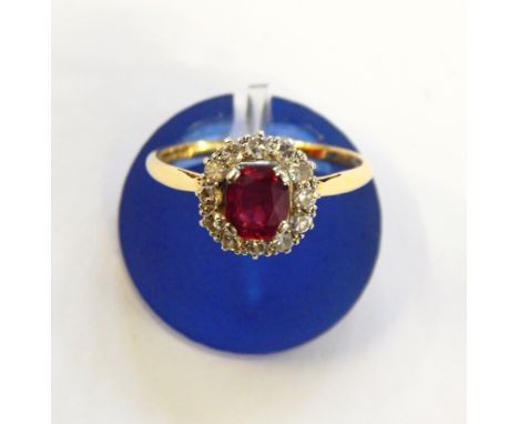 18ct gold, ruby and diamond cluster ring set oval ruby surrounded by old cut diamonds 
