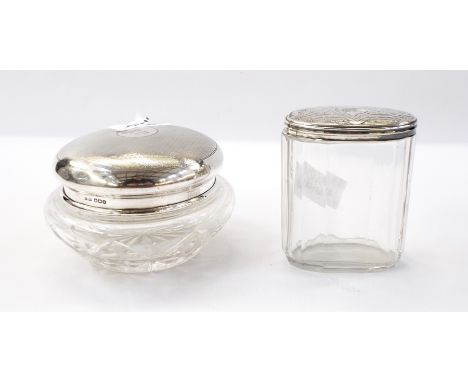Edwardian silver-topped circular cut glass jar with engine-turned decoration, Birmingham 1908 together with oval cut glass ja