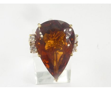 Dress ring with pear shaped citrine flanked by four diamonds in 18ct gold. Size 'O 1/2'. 