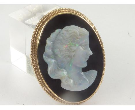 Cameo brooch with carved opal portrait of a woman upon onyx in 9ct gold. 