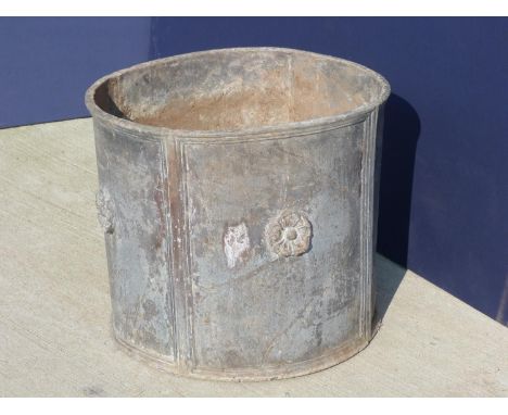 Large 19th century lead garden planter, four panels with central rose in relief (with drainage holes and some partial concret