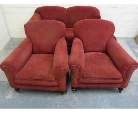 19th century upholstered three piece suite comprising a two seat drop end sofa and two armchairs, raised on bun supports also