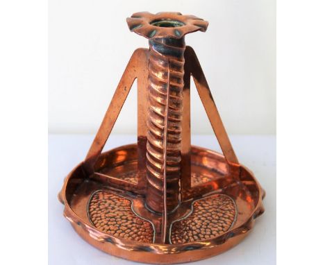 Arts and Crafts copper candlestick, the twist column with three pierced supports and galleried circular base with three beate