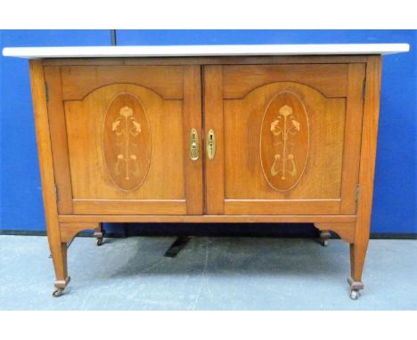 Art Nouveau style oak marble top wash stand enclosed by a pair of inlaid doors raised on scroll supports. 107cm. 