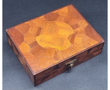 A parquetry playing card box, the hinged lid decorated with a swastika, 15.5cm wide; enclosing two packs of Royal Tank Corps 