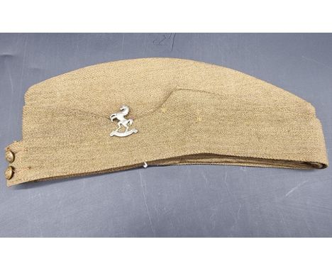 A WWII British army khaki side cap, with Queens Own Royal West Kent cap badge, stamped to interior 'J Collett Ltd, 1942', siz