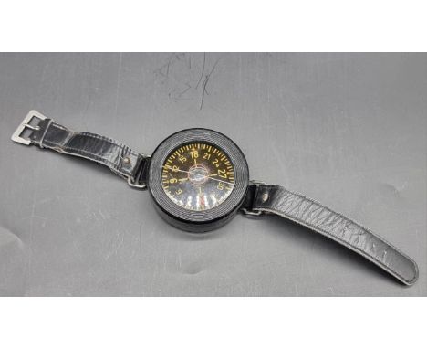 A WWII German Luftwaffe pilot's AK39 wrist compass, stamped to reverse 'FL 23235', with original strap and buckle.