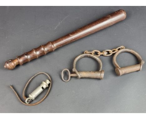 A hardwood truncheon, 39cm; together with a pair of steel hand cuffs with key and a 'The Metropolitan' whistle. (3)
