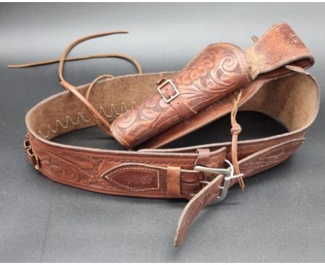 A Mexican leather holster, by Viking, with matching belt.