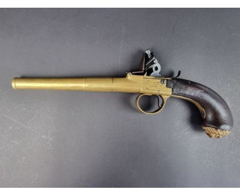 An 18th century flintlock travelling pistol, having 17cm brass screw-off canon barrel, the brass action signed to one side 'T