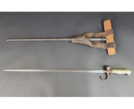 A French M1886 Lebel bayonet, scabbard and leather frog, with 52cm cruciform blade, Serial No. R 94968, overall length 64cm.
