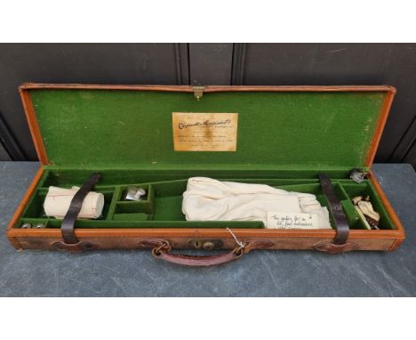 A leather mounted canvas shotgun case, labelled 'Cogswell &amp; Harrison Ltd', containing cleaning and other accessories.