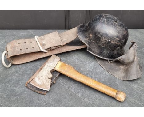A WWII German M34 fireman's helmet; together with a fire axe; and leather belt. (3)