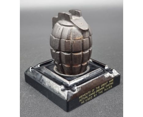 A WWI novelty grenade inkwell, the&nbsp;pottery base inscribed 'Memento of The Great War, Actual Hand Grenade Casting, As Use