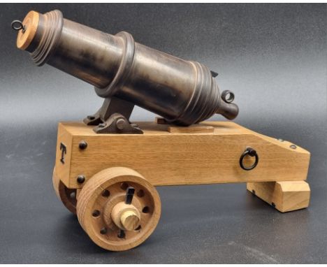 A scratch built model of a late 18th century naval cannon, on oak carriage, total length 31cm.