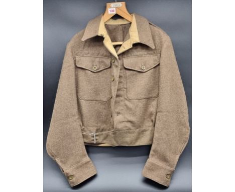 A WWII British Army 1940 pattern battledress blouse, size 13, having officer's rank insignias to epaulettes and XXX Corps for