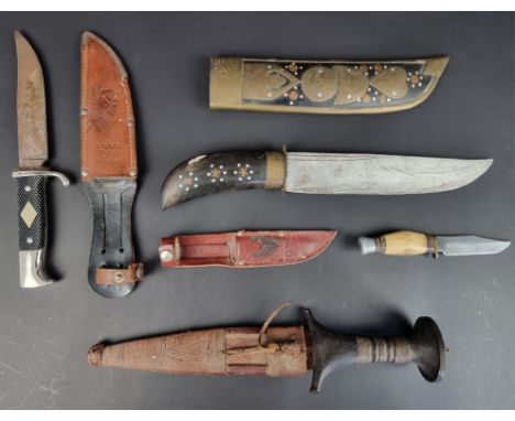 A Sudanese arm dagger and sheath; together with three sheath knives. (4)