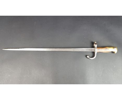 A French M1874 bayonet, the 52cm blade inscribed&nbsp;'Mre d'Armes de Chat-Avril 1878'.