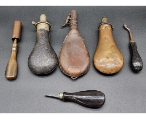 A 19th century leather and steel shot flask, 22cm high; together with two other shot flasks; a Gunsmith's nipple key; a Gunsm