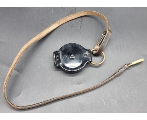 A WWII German marching compass, marked MK 122058, by Max Kohl, with original leather lanyard.