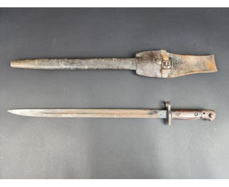 A British WWI pattern 1907 Lee Enfield sword bayonet and leather scabbard, stamped Wilkinson, with 43cm blade and leather fro