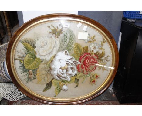 A Victorian beadwork and tapestry work oval floral picture within a rosewood frame   