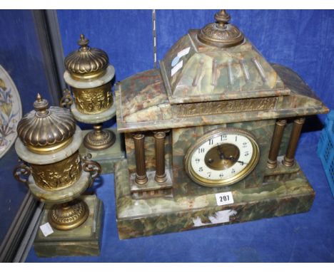  An early 20th Century green onyx and gilt metal mounted mantel clock  , 40m high with matching pedestal urns, 31cm high 