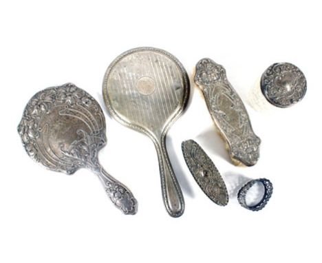 Five silver mounted dressing table items and a silver napkin ring, various dates and makers Poor