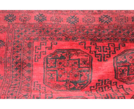 A Turkoman rug of tekke design, the claret field with two rows of five medallions, 295 x 210 cm  light wear, frayed ends 