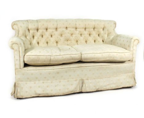 A two seated sofa button upholstered and covered in ivory damask on mahogany supports with ball and claw feet Cover stained