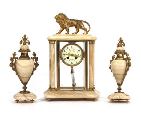 A late 19th century three piece garniture, comprising a mantel clock with painted ivorine dial supporting a twin train moveme