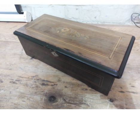 A late 19th century 8 airs rosewood cylinder music box, length 43cm.Condition:- General wear through age and use, one comb to