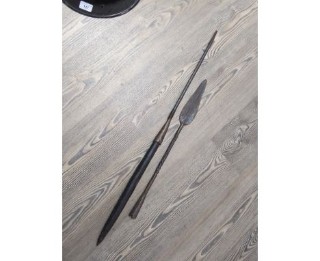 An African spear with carved wood handle together with an African spearhead.