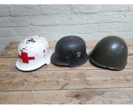 A reproduction WW2 German M40 M-1940 helmet, ORG. TODT. together with a possibly Italian helmet, dated 1960 and a WW2 German 