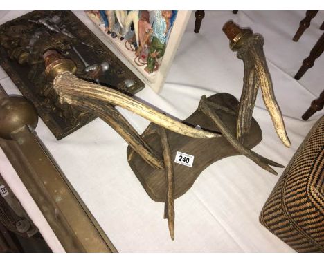 A double wall light made of antlers