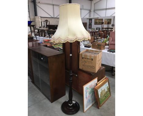 A drak wood stained standard lamp