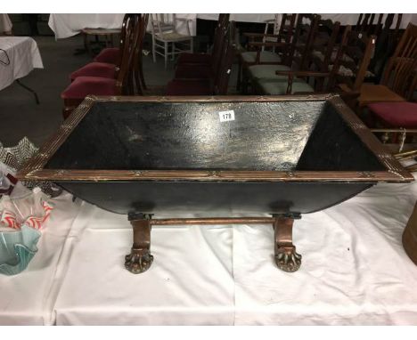 A copper rimmed painted log trough