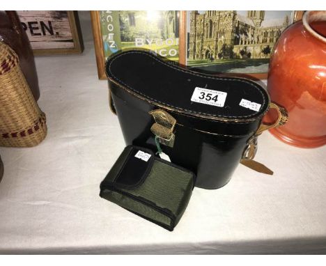 A vintage leather case, Russian binoculaurs etc