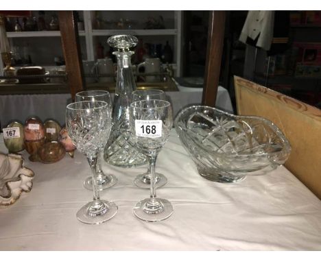 A cut glass decanter and 4 glasses and a bowl