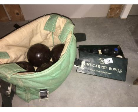 A set of 4 lawn bowls and a set of carpet bowls