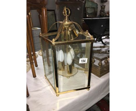 A brass five sided ceiling light with bevelled glass panels