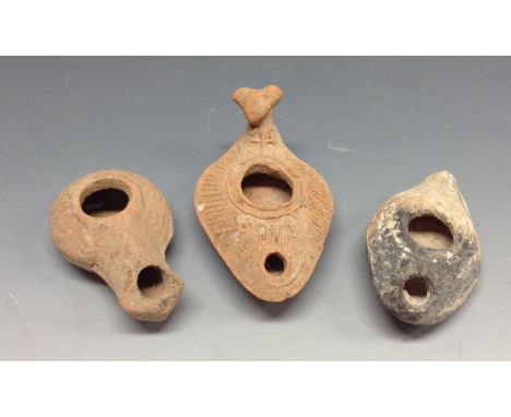 Antiquities - a Roman terracotta oil lamp, moulded with geometric motifs, 10cm long; others (3)