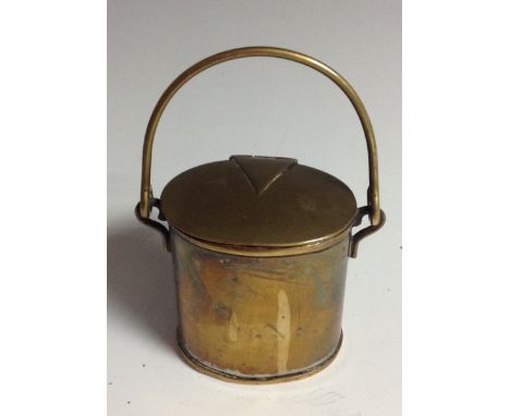 A 19th century brass novely inkwell, as a milk can, hinged cover enclosing a ceramic liner, arched carrying handle, 6cm high