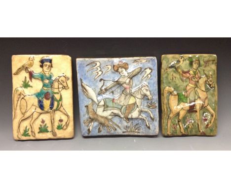 A Middle Eastern square tile, boldly moulded with a hunting scene, crackel blue ground, 19cm high, 19.5cm wide; a Middle East