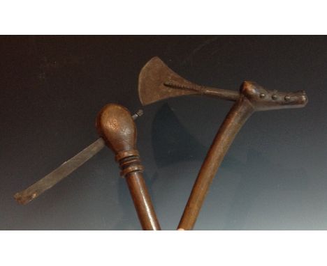 Tribal Art - an African axe, fan shaped blade with notched ridge, the hooked head studded, sliightly curved shaft, 53cm long,