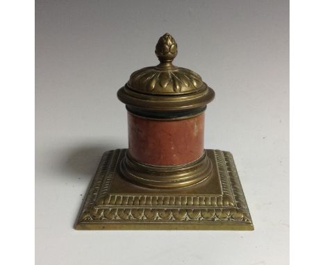 An early 20th century veined marble and brass columnar inkwell, hinged cover with bud finial, stepped square base with lotus 