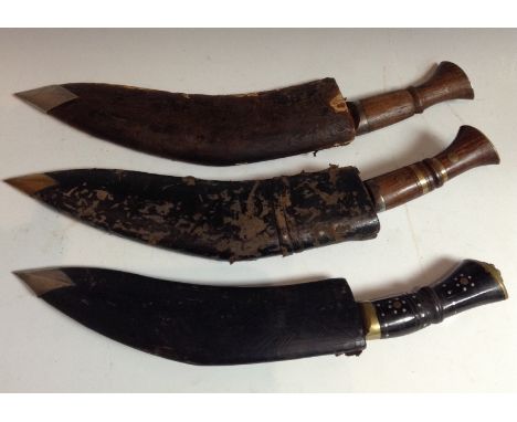 A kukri, 30.5cm curved single-edged blade inscribed Military Supply Syndicate, rosewood grip with brass bands and roundels, b