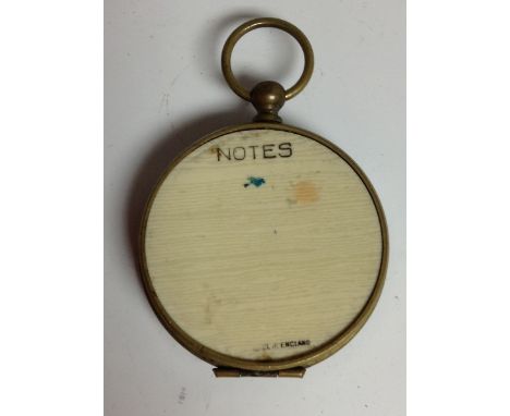 An early 20th century brass pocket sun dial and compass, 4.5cm paper scale, ivorine aide memoir to verso, 7.5cm over loop