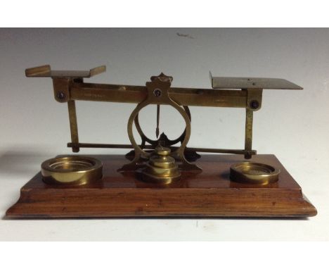A set of postal scales, by S. Mordan & Co. London, stamped, 1-8oz weights en suite, mahogany plateau base, 10cm high, c. 1910
